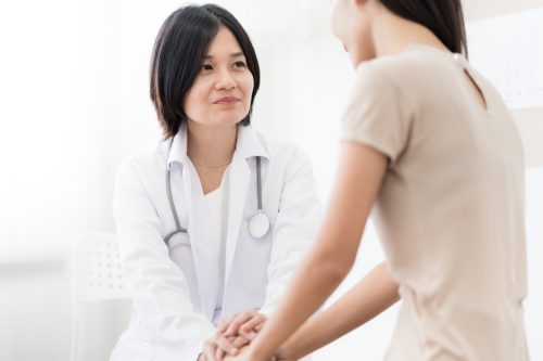 woman at the doctor ways we're unhealthy