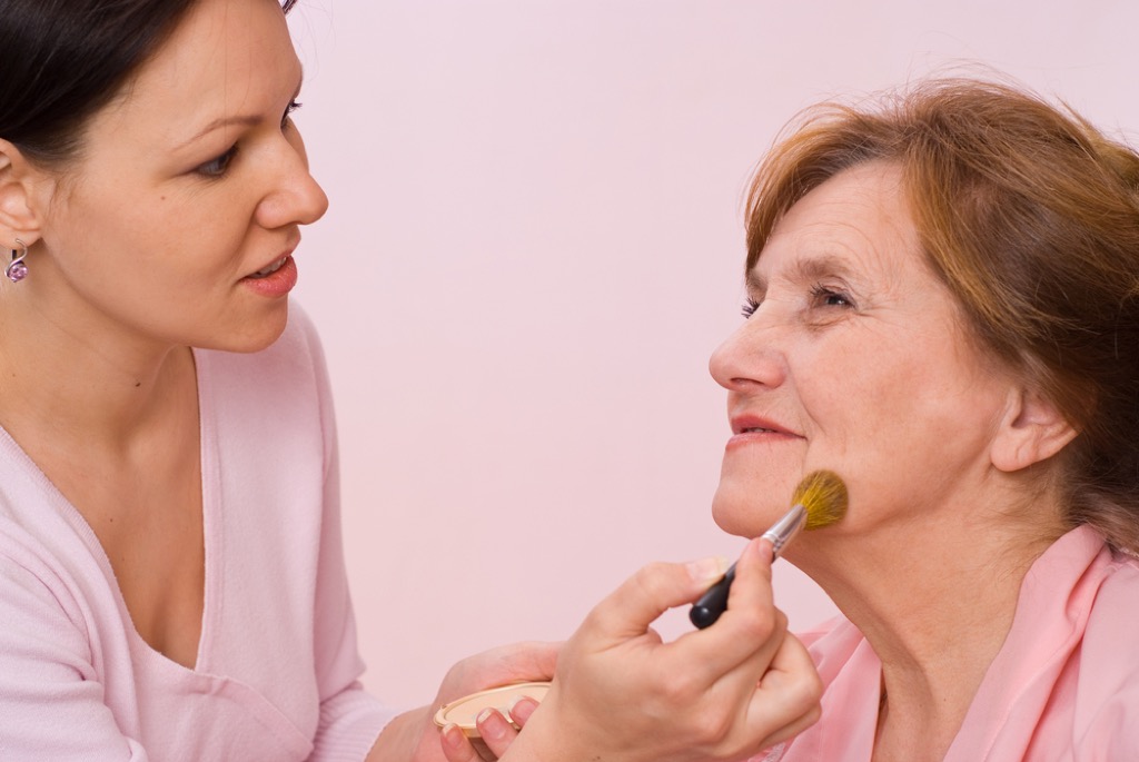 older woman having makeup applied, look better after 40