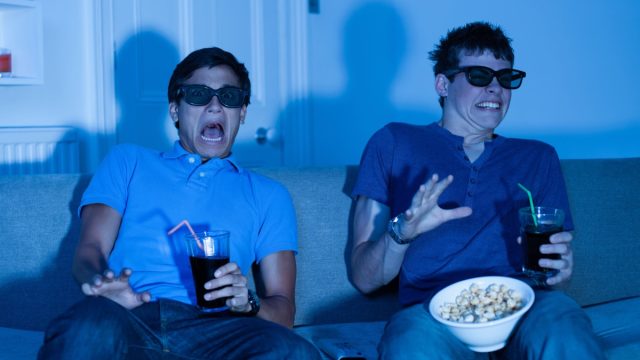 Two boys scared watching a scary movie