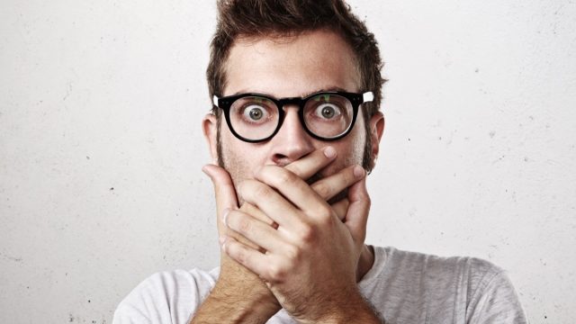 a shocked man with glasses and a fauxhawk against an off-white background, predictions that came true