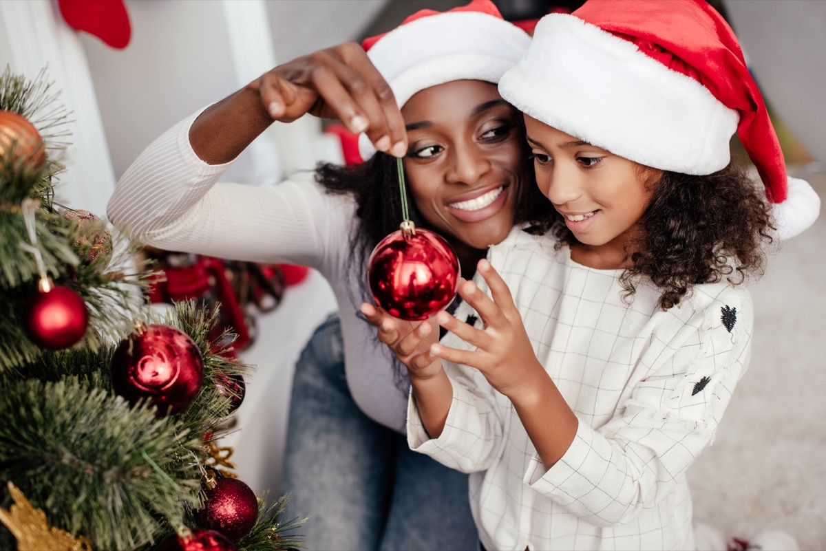 family putting up their christmas tree decorations