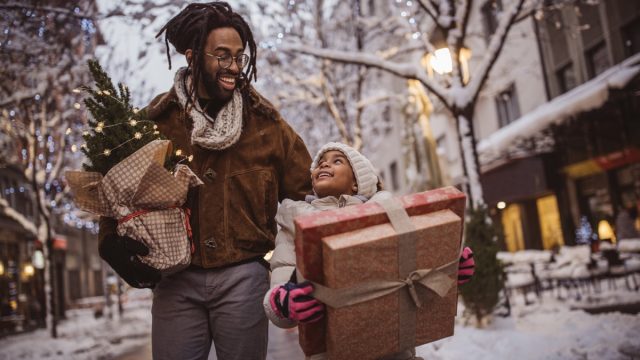 a young family preparing to give back this holiday season with presents in hand