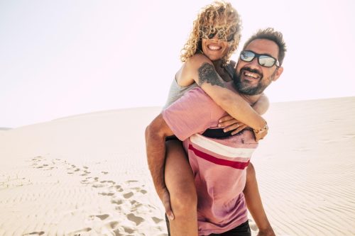 Happy couple over 40 in the desert enjoying themselves on adventure