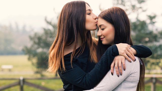 sisters hugging outside