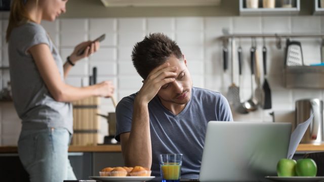 couple ignoring each other in the kitchen, things you should never say to your spouse
