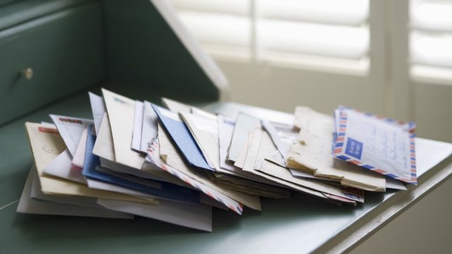 Pile of Mail on a Desk {Secrets Your Mailman Knows}