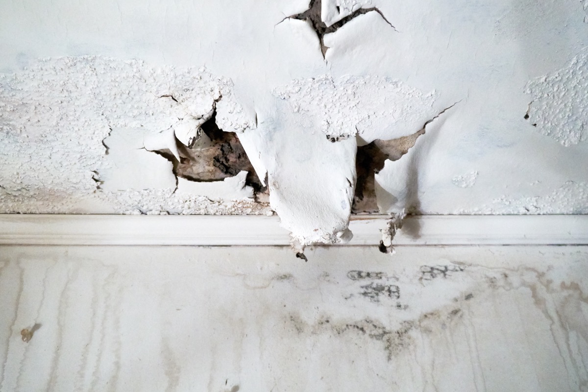 Ceiling and wall with rain damage due to violent weather and roof damage