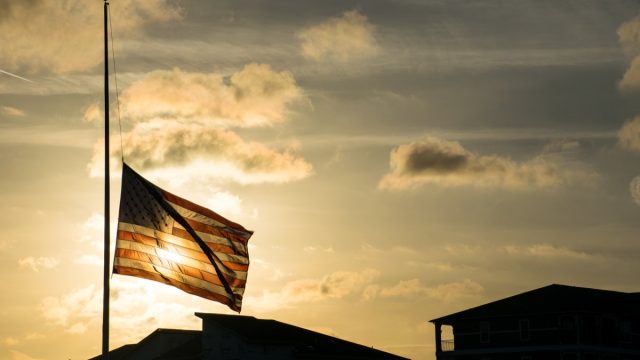 flag at half staff at sunset