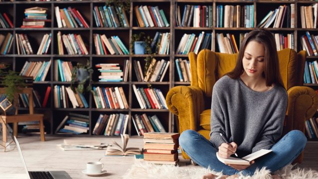 Girl reading book library