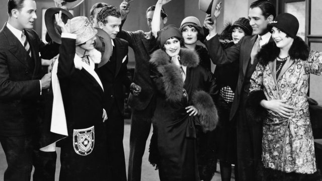 a group of men tipping their hats to a group of women