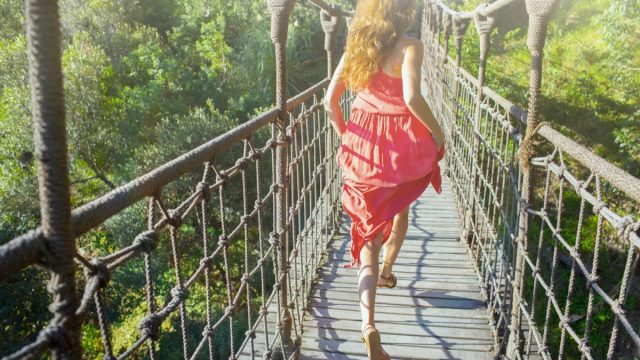 woman running across bridge in life experience