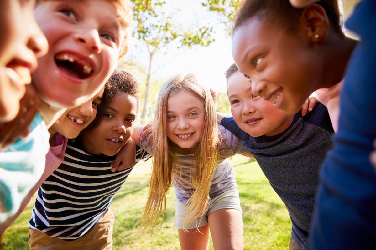 school kids laughing in circle