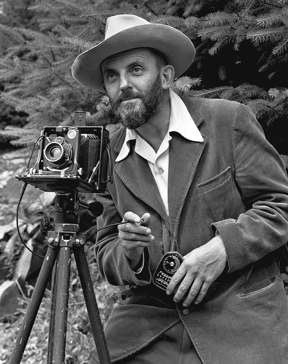 Photographic portrait of nature photographer Ansel Adams — which first appeared in the 1950 Yosemite Field School yearbook. The camera is probably a Zeiss Ikon Universal Juwel.