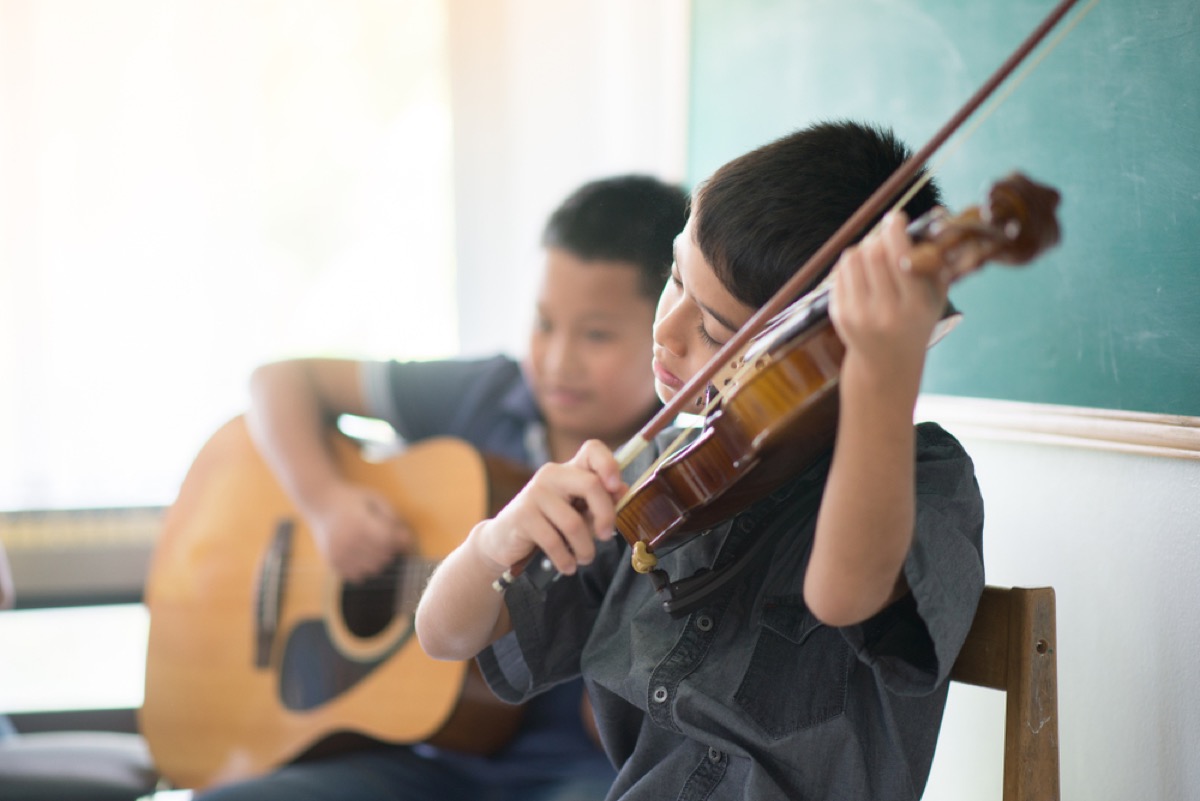 two young boys playing violin and guitar, bad parenting advice