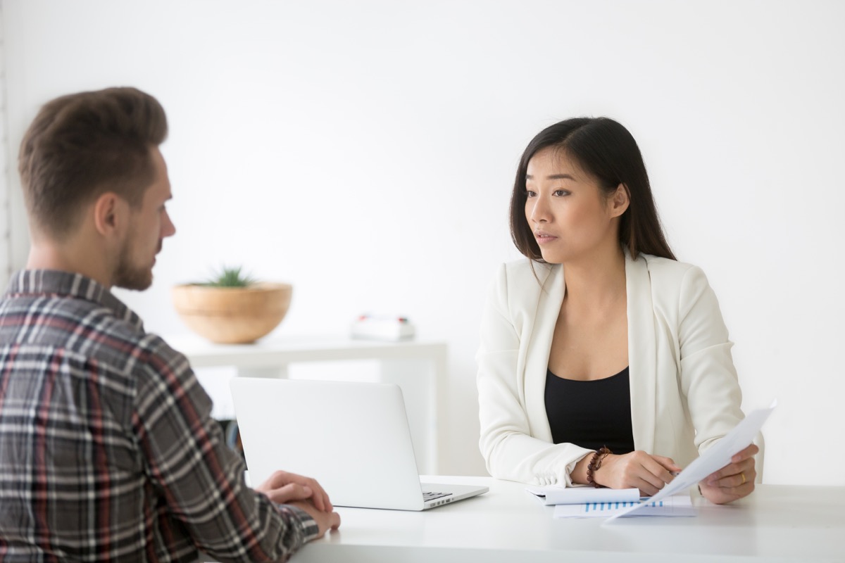 Woman interviewing man in office