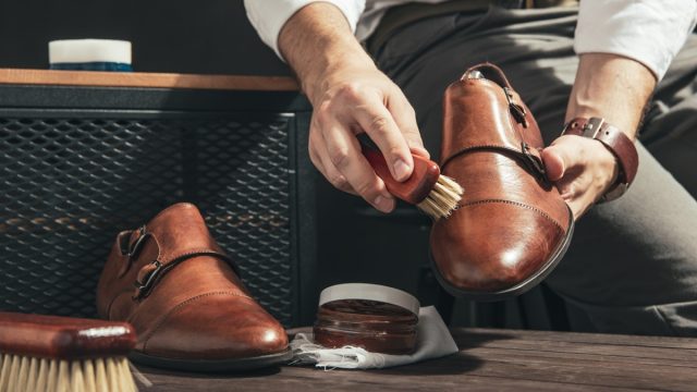 man shining light brown double monk strap shoes