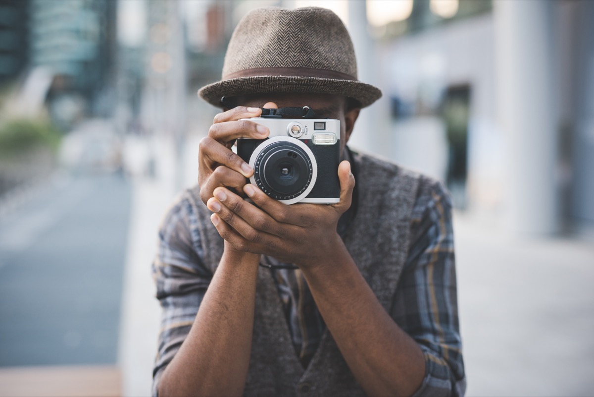 Man taking photo with vintage camera