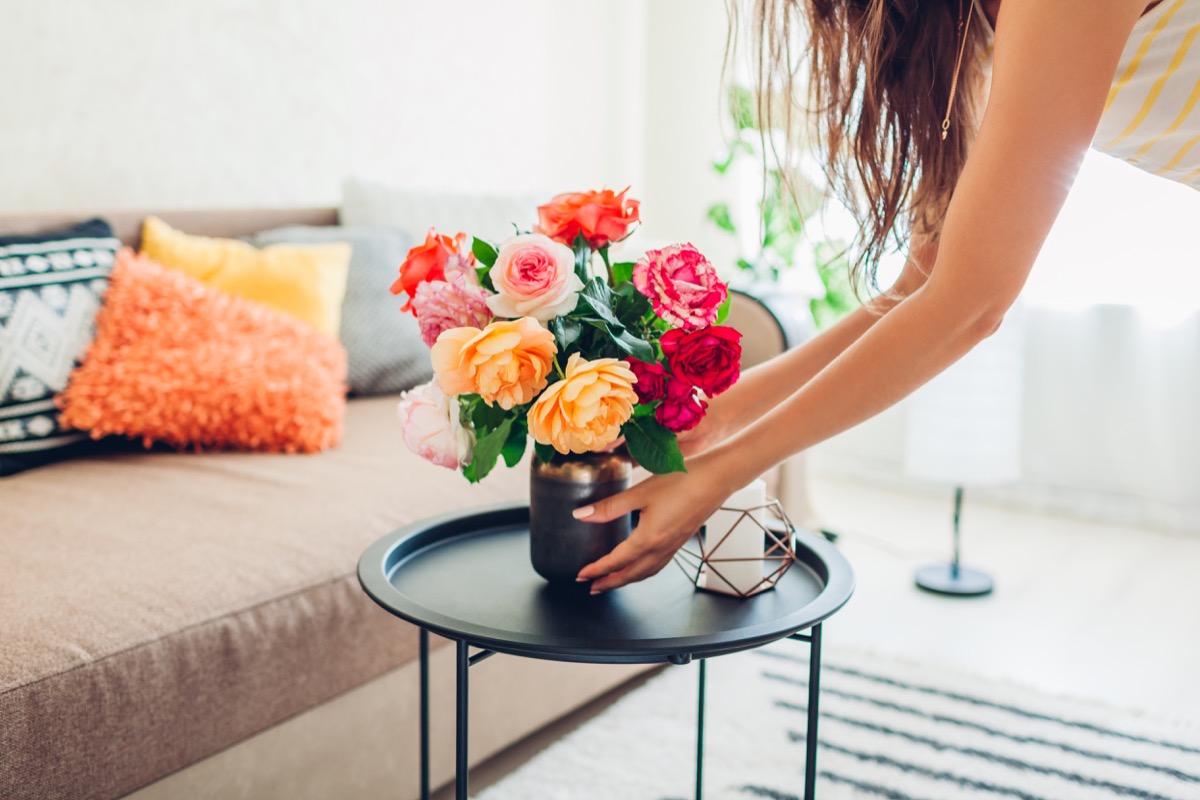 Woman putting out flowers