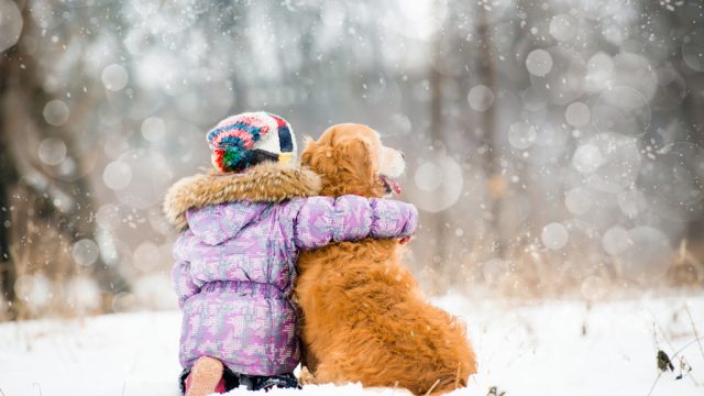 little girl hugging dog in winter, skills parents should teach kids