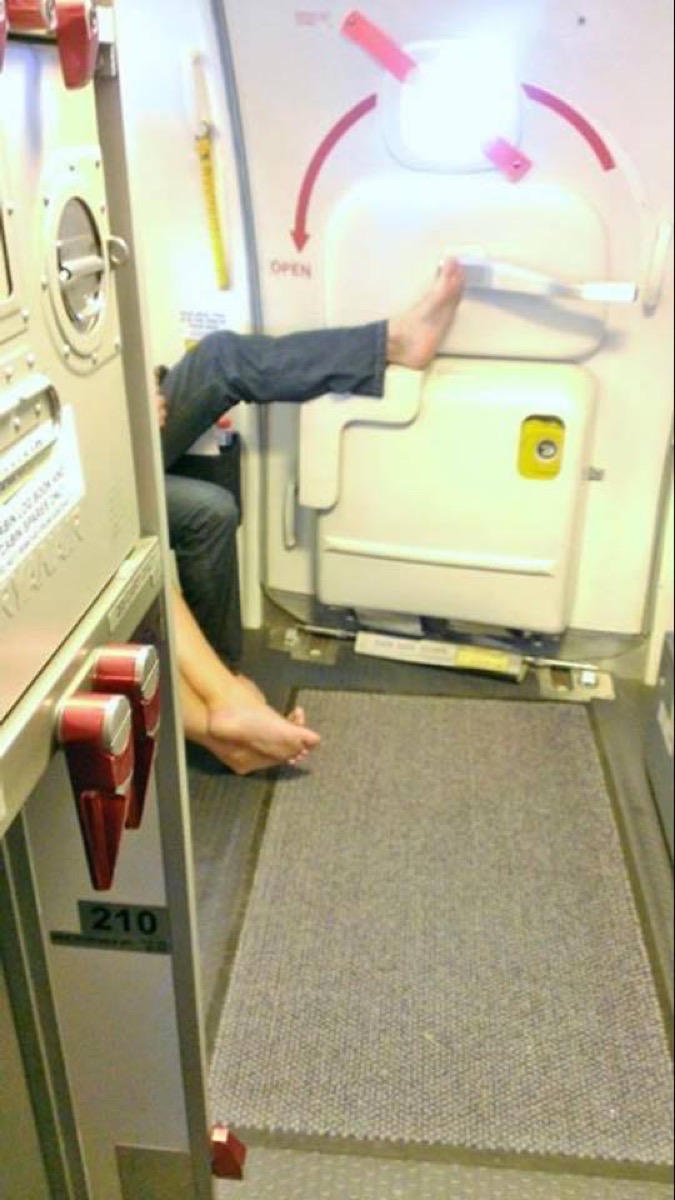 Airline passenger touching handle with foot photos of terrible airplane passengers