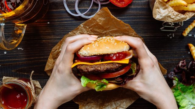 Person holding a burger