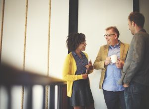 coworkers chatting during an office coffee break