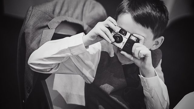 boy using a disposable camera