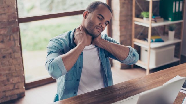 Man experiencing neck pain