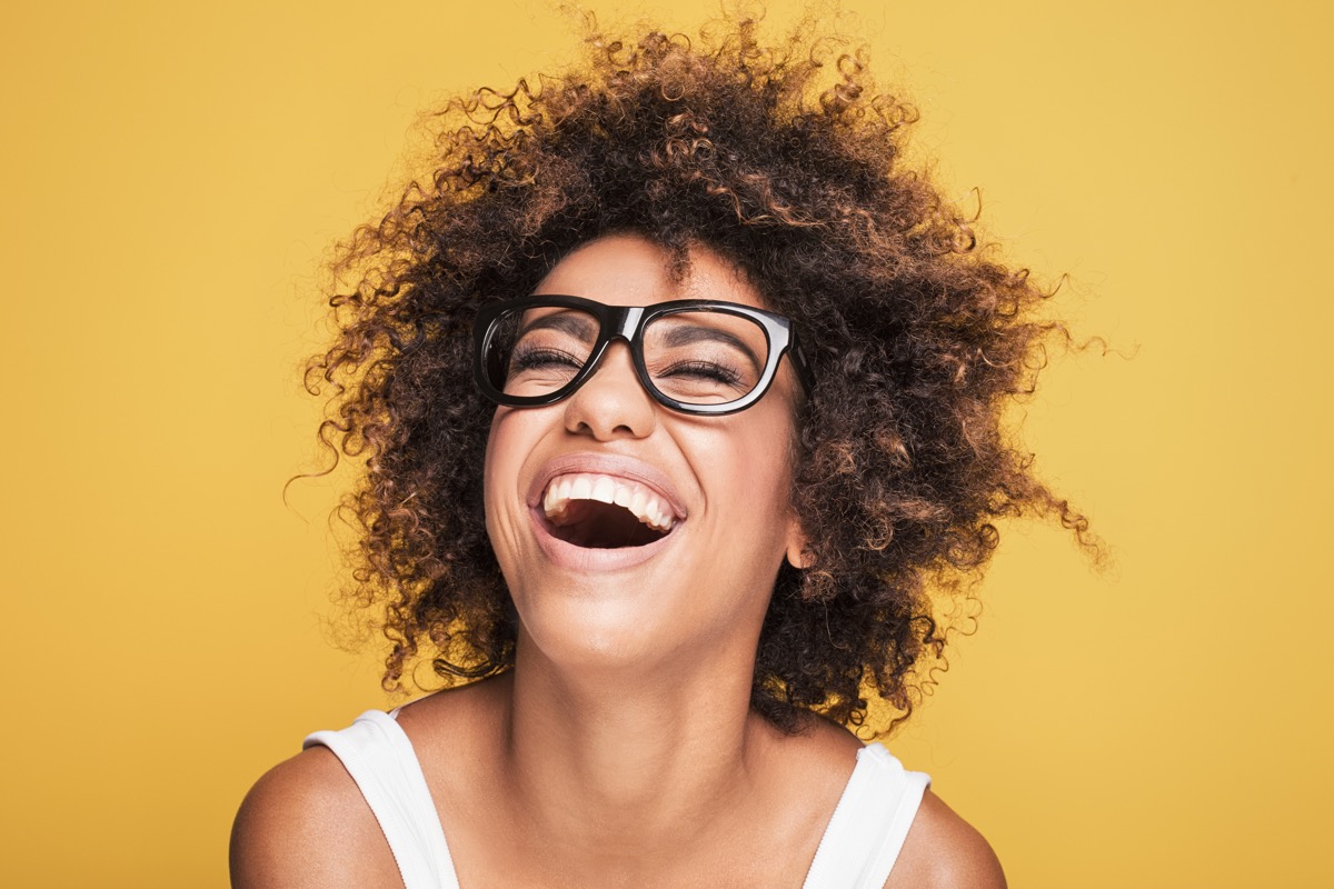 woman laughing on gold background, funniest words