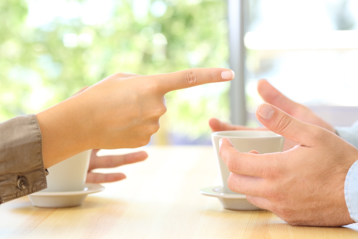 close up of the hands of a couple arguing with woman pointing finger at man, things you should never say to your spouse