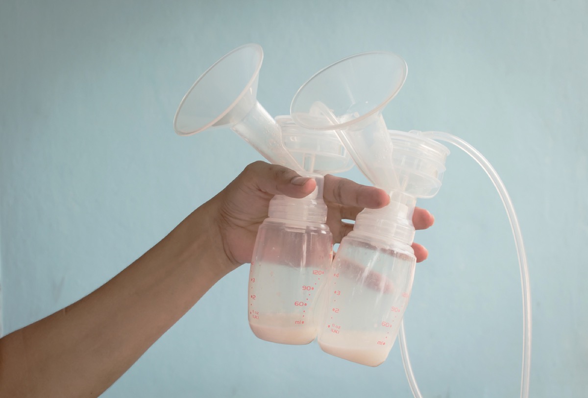 woman holding breast pump, breastfeeding, working mom