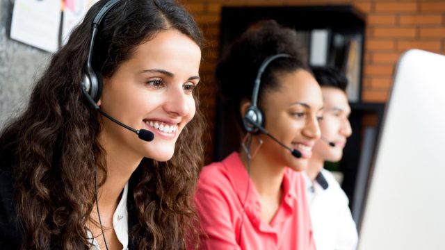 group of telemarketers taking calls at work