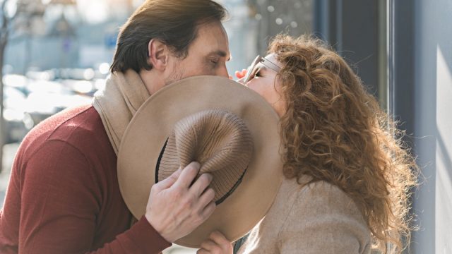 man and woman kissing in the street