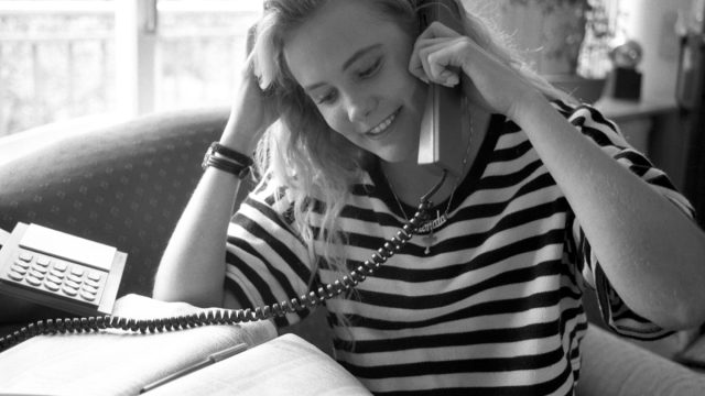 1980s photo of a woman calling someone to ask out, 1980s nostalgia