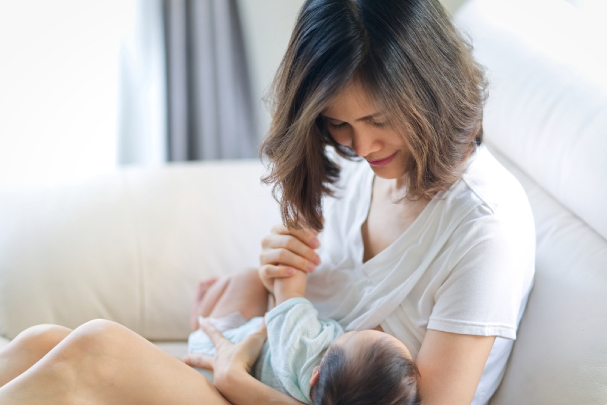 asian woman breastfeeding baby, how parenting has changed
