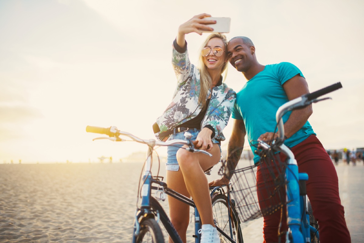 attractive interracial couple on bikes taking selfie signs you're in a relationship for the wrong reasons