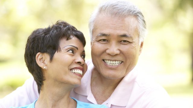 older couple being affectionate outdoors, long marriage tips