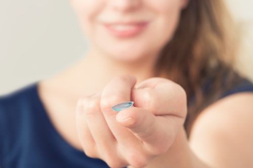 woman holding colored contact