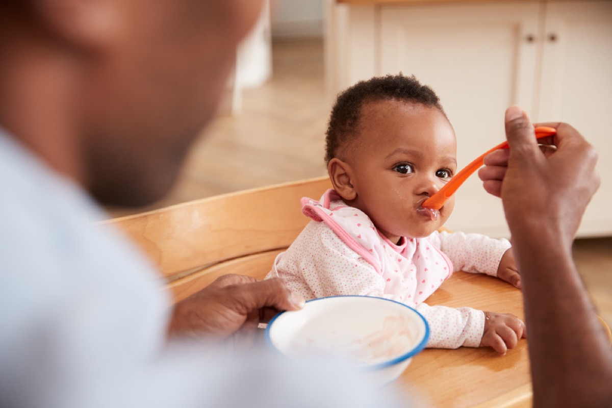 father feeding baby daughter, how parenting has changed
