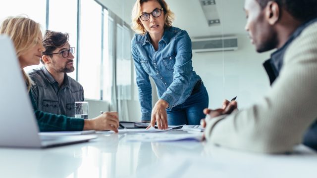 Female boss leads meeting of multiethnic staff