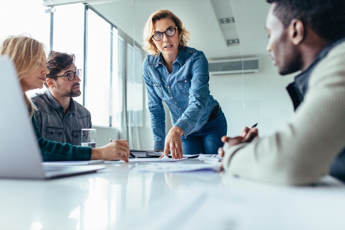 Female boss leads meeting of multiethnic staff, office etiquette that's outdated