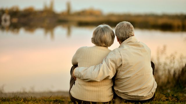 happy elderly couple gazing at sunset, healthy sex after 40