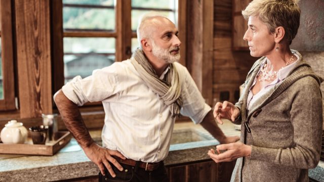 older couple fighting with each other in kitchen