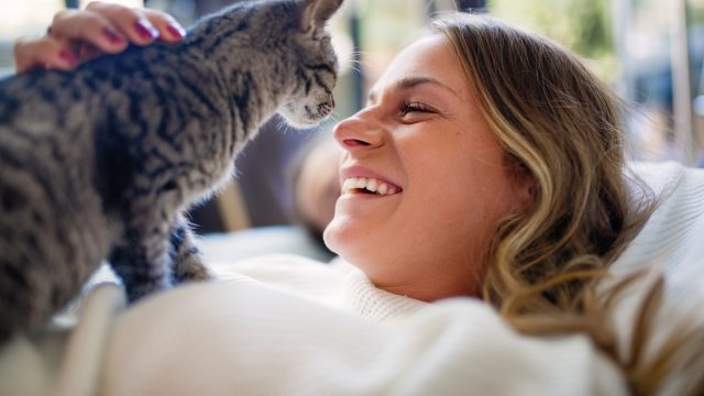 owner laughing with her cat