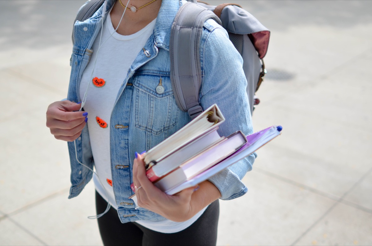 woman holding school supplies, back to school mistakes