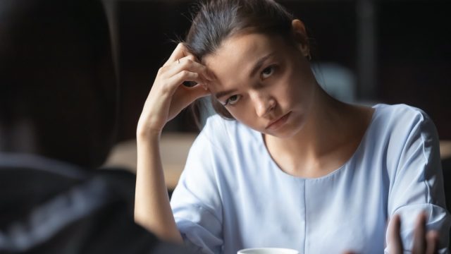 Woman looking annoyed at her companion