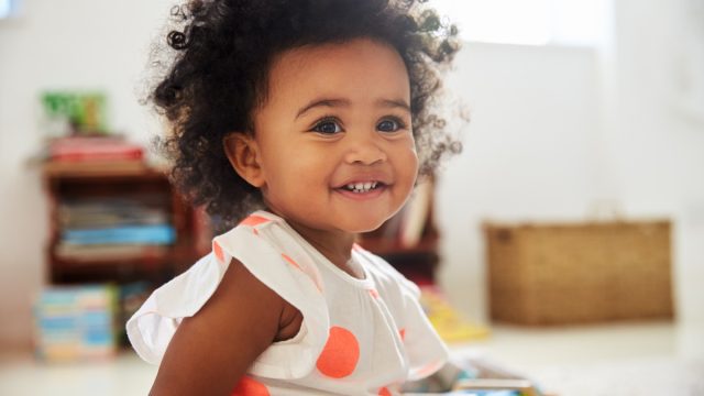 Happy Baby Toddler Playing With Toys In Playroom