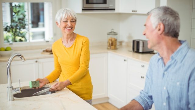 older white straight couple cleaning kitchen