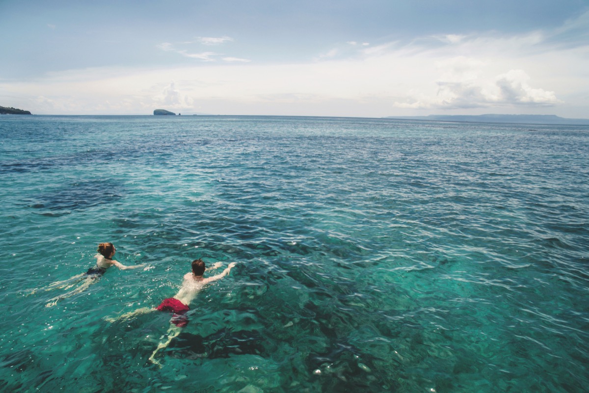 Two people swimming in the ocean