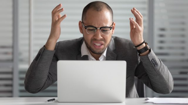 man angry at laptop